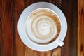 Top view of hot coffee latte cappuccino cup on plank wood table Royalty Free Stock Photo