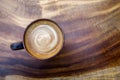 Top view of hot coffee latte cappuccino cup on wood texture back Royalty Free Stock Photo