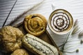 Top view hot coffee white cup,with bakery and coffee beans in hemp bag,placed on white wood table,With sunshine in morning,beauty Royalty Free Stock Photo