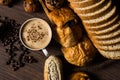 Top view hot coffee in white cup with smoke,bakery and coffee beans in hemp bag placed on dark brown wood table,Beauty concept of Royalty Free Stock Photo