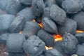 Top View Of Hot Flaming Charcoal Briquettes Glowing In The BBQ Grill Pit. Abstract Red Black Background, Texture Or Wallpaper. Royalty Free Stock Photo