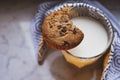 Top view of hot milk in a glass and a chocolate chip cookie Royalty Free Stock Photo