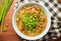 top view of hot and sour soup with green onions sprinkled