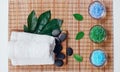 Top view of hot stones setting for massage treatment on blackboard with copy space.Towel, Salt, Plumeria Flower, Bowl for spa ther Royalty Free Stock Photo