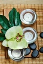 Top view of hot stones setting for massage treatment on blackboard with copy space.Towel, Salt, Plumeria Flower, Bowl for spa ther Royalty Free Stock Photo