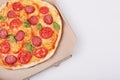 Top view of hot tasty pizza in box with ham sliced and served on white table, close up view. Fast food, junk food and nhealthy