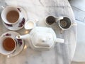 Top view of hot tea with milk and jar,tea break time on marble table Royalty Free Stock Photo