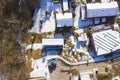 Top view of a house with a snowy roof. Shooting with a drone