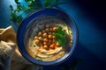 Top view of hummus in blue ceramic bowl with parsley. Generate ai Royalty Free Stock Photo