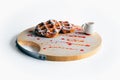 Top view of Hybrid of chocolate croissant and Waffle topped with icing sugar and strawberry sauce with syrup on wooden plate, Royalty Free Stock Photo