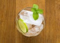 Top view of ice cubes in a glass with sliced lemon and fresh min