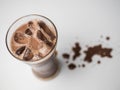 Top view iced chocolate or cacao in clear glass on white background in side view with copy space. Concept to present