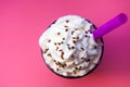 Top view of iced coffee topped whipped cream with purple plastic Royalty Free Stock Photo