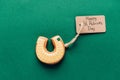 top view of icing cookie in shape of horseshoe on green, st patricks