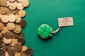 top view of icing cookie in shape of shamrock and golden coins on green, st patricks