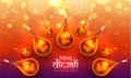 Top view of illuminated realistic oil lamps on shiny blurred background with stylish lettering of Happy Diwali. Can be used