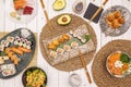 Top view image of Asian food dishes. California roll, avocado with pepita, red tuna and salmon sashimi, assorted sushi, salmon Royalty Free Stock Photo