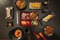 Top view image of Asian food and sushi. Salmon makis, roast duck, frie breaded chicken, salmon uramakis,