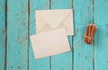 Top view image of blank letter paper and envelope next to colorful pencils on wooden table. vintage filtered and toned