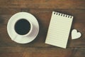 Top view image of blank notebook next to cup of coffee. vintage filtered and toned