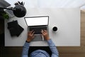 Top view image of businessman hand typing on computer laptop with blank screen at working desk with office equipment. Royalty Free Stock Photo