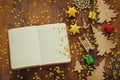 Top view image of christmas festive decorations next to empty open notebook on old wooden background Royalty Free Stock Photo