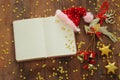 Top view image of christmas festive decorations next to empty open notebook on old wooden background Royalty Free Stock Photo