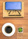 Top view image of coffee cup and cellphone on wooden table Royalty Free Stock Photo