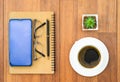 Top view image of coffee cup and cellphone on wooden table Royalty Free Stock Photo