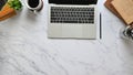 Top view image of computer laptop putting on marble texture table.