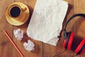 Top view image of crumpled paper next to headphones and cup of coffee over wooden table Royalty Free Stock Photo