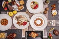 Top view image of a delicious dish of Spanish food, grilled gilthead bream, pork cheek, chicken wings with fried egg, salmon Royalty Free Stock Photo