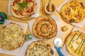 Top view image of delicious and original pizzas with pear, mushrooms, pesto sauce, green asparagus and fried eggs on pine wood Royalty Free Stock Photo