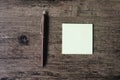 Top view image of empty sticky note paper and pen on the wooden