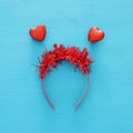 Top view image of funny party head glitter accessory with hearts. Flat lay.