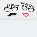 Top view image of funny photo booth props with text: HIS, HERS for party or wedding over white background. Royalty Free Stock Photo