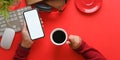 Top view image of hands holding a white blank screen smartphone and hot coffee cup . Royalty Free Stock Photo