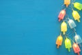 Top view image of ice cream cute party garland lights over wooden blue background.