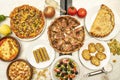 Top view image of Italian food dishes, stuffed calzone, pizza with bacon, garlic bread, Mediterranean salad, Royalty Free Stock Photo