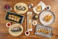 Top view image of Japanese food sticks. Shrimp in tempura, california roll, salmon and red tuna maki, fried gyozas, soy sauce, Royalty Free Stock Photo