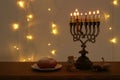 Top view image of jewish holiday Hanukkah background with traditional spinnig top, menorah traditional candelabra Royalty Free Stock Photo