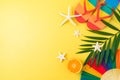 Top view image of LGBTQ pride month beach party background with rainbow flip flops, palm leaf and paper fan. Flat lay