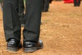Top view image, light and shade Male soldiers wear black shoes standing on the floor during the day time.