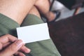 A man`s hand holding empty business card while sitting in cafe Royalty Free Stock Photo