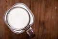 Top view image milk in a jug and a glass on wooden table.