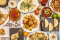 Top view image of nachos with avocado guacamole, complete burritos, corn tacos al pastor, cochinita pibil. Chicken wire, fajista, Royalty Free Stock Photo