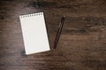 Top view image of open notebook with blank page and pen on the wooden table. Royalty Free Stock Photo