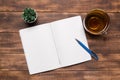 top view open notebook with blank pages next to cup of coffee on wooden table. ready for adding text or mockup Royalty Free Stock Photo