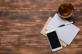 Top view image of open notebook with blank pages next to cup of coffee on wooden table. ready for adding text Royalty Free Stock Photo