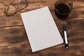 top view image of open notebook with blank pages next to cup of coffee on wooden table. ready for adding text Royalty Free Stock Photo